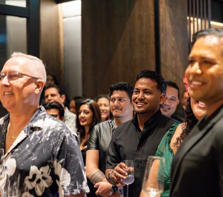 Guests smiling during a speech at a corporate function